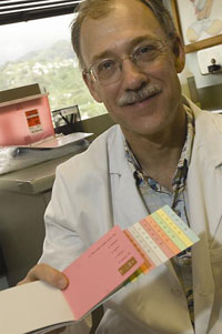 Neurology researcher G. Webster Ross, MD, of the Honolulu VA Medical Center displays a scratch-and-sniff booklet used to test patients' sense of smell, as a possible aid to early detection of Parkinson's disease.