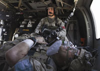 New look at battle  Army Sgt. Jesse Rosenfield, a flight medic with Task Force Thunder Brigade, tends to an injured soldier aboard a Blackhawk helicopter in Kandahar province, Afghanistan, in April 2011. VA and DoD experts are teaming up to drive new research on posttraumatic stress and traumatic brain injury, which affect significant numbers of Iraq and Afghanistan Veterans.