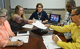 Dr. JoAnn Kirchner (center) meets with QUERI team members (from left) Dr. Mona Ritchie, co-implementation research coordinator; Krissi Morris, program coordinator; Dr. Mark Bauer (via computer), lead investigator in Boston; Mark Bowman, research assistant; and Jeffery Pitcock, data coordinator. Not shown is team member Jeffrey Smith, implementation research coordinator. 