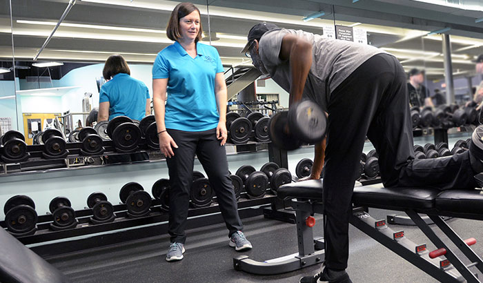 Dr. Katherine Hall helps a Vet with his workout at the Durham VA Medical Center. (Photo by Linnie Skidmore) 