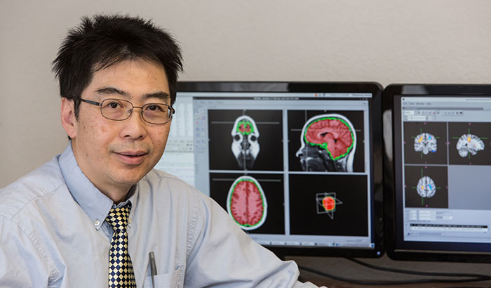 Dr. Mingxiong Huang is a neuroimaging scientist at the VA San Diego Health Care System. (Photo by Kevin Walsh)  