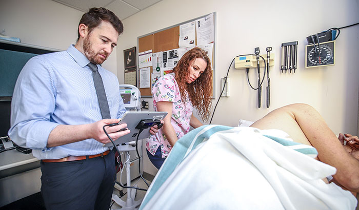 Researcher Dr. Matthew Peterson and nurse Trina Dickert use an experimental new automated system for measuring bedsores, or pressure ulcersâ€”a common problem for Veterans with spinal cord injury, as well as other patient populations. (Photo by Dan Henry)  