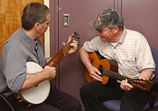 Dr. Charles Levy, playing banjo, jams with guitarist Billy Mize, who visited the Gainesville VA to take part in an innovative speech therapy program. 