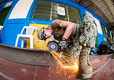 A U.S. Navy seaman cuts a metal beam at an engineering site in El Salvador. The country is among those with a relatively high prevalence of T. gondii infection.
