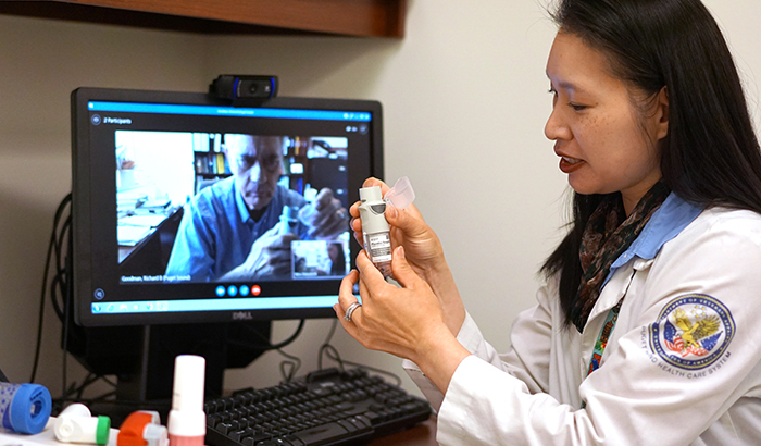 Pharmacist Deborah Woo demonstrates the video-training technique used in the study. 