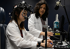 Dr. Fatema Ghasia (right) works with medical student Sarah Kang to test eye movements in able-bodied subjects. (Photo provided by Cleveland FES Center)   