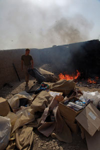 The military used open-air burn pits like this one, photographed in 2009 at a Marine base in Afghanistan, to incinerate a wide range of trash items, such as chemicals, paints, medical and human waste, plastics, wood, and food. VA and Defense research is ongoing into the possible health effects of exposure to smoke from the pits. 