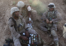 
Navy corpsmen tend to a Marine wounded in a firefight in Afghanistan in 2009. VA researchers are studying the after-effects of trauma—not only the negative ones, but the 