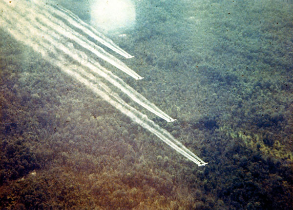 A UC-123 sprays defoliant as part of Operation Ranch Hand during the Vietnam War. <em>(Photo: National Museum of the U.S. Air Force)</em> 