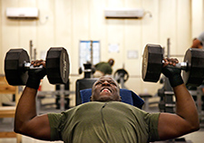 U.S. Marine Corps Cpl. Daniel Pritchett performs dumbbell incline presses in the fitness center on Camp Leatherneck in Helmand province, Afghanistan, in 2013. A new VA study aims to pinpoint the specific chemicals generated during exercise that boost brain health. 