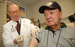 Dr. Michael Simberkoff administers a shot to Veteran Marco Antonio at the VA New York Harbor Healthcare System. (Photo by Lamel Hinton) 