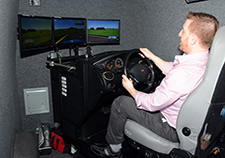 Nicholas Bartolomeo, who served three tours with the Marines in Iraq and now works at VA's Center of Innovation on Disability and Rehabilitation Research in Gainesville, Fla., demonstrates a driving simulator used in research at the center.  