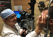Dr. Yang Sun, an ophthalmologist, performs an exam for a VA patient. (Photo by Dr. Scott Wentz)