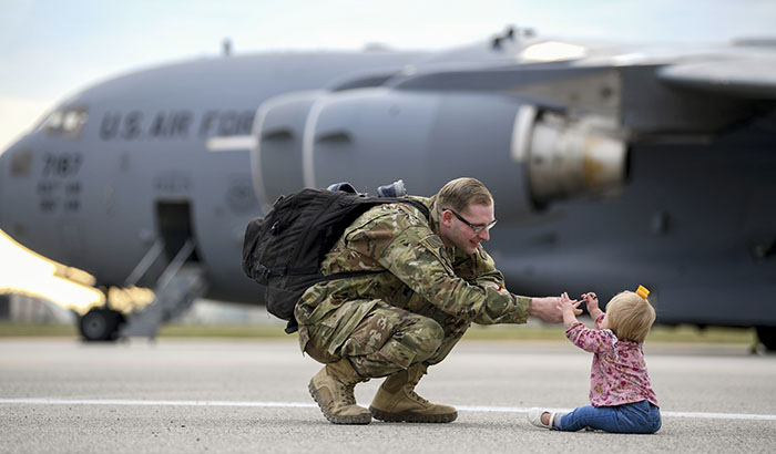 An airman reunites with his daughter following a deployment. (Photo by USAF Airman 1st Class Ericka Woolever)</p>
 