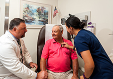 Instructor Dr. Randy Moore (left) and recent nursing graduate Chenoa Leopard meet with Birmingham VA patient Kenneth Hollingshead.  