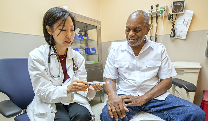 Dr. Mary Rhee, a physician-researcher with the Atlanta VA and Emory University, discusses the use of an insulin pen with VA patient Joseph Fields. (Photo by Lisa Pessin)   