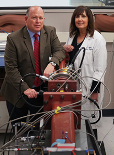 Study co-authors Drs. David Cook and Elaine Peskind, with the Puget Sound VA and University of Washington, use a device called a shock tube (shown in foreground) to simulate blasts in rodent models so they can better understand what happens in the brains of soldiers exposed to blasts. (Photo by Christopher Pacheco) 