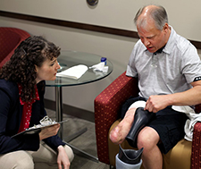 A Veteran amputee discusses his prosthetic socket liner with Courtney Shell, a research associate at the APT Center. (Photo by Jennifer Kerbo) 