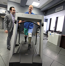 Ed Sliwinski, a prosthesis user and prosthetics technician, walks on a treadmill under the watchful eye of Dr. Leif Nelson, assistant chief for clinical care in the Extremity Trauma and Amputation Center of Excellence. 