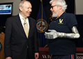 Dr. Joel Kupersmith shares a light moment with Vietnam-era Veteran Artie McAuley at a VA headquarters event during National VA Research Week in 2012. McAuley, who lost his arm in a car accident in 1969, participated in VA tests of the DEKA advanced prosthetic arm. (Photo by Emerson Sanders)