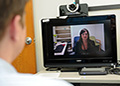 Remote healing-PTSD therapy delivered through videoconferencing proved effective in one of the largest trials yet of the approach. Seen on the screen is study coordinator Janel Fidler of the VA San Diego Health Care System. (Photo by Christopher Menzie)
