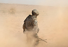 A U.S. Army soldier braves a cloud of dust near the Iraq-Iran border in 2009. A new study found an increase in chronic lung disease between 2003 and 2011 among VA patients who served in Iraq or Afghanistan. <em>(DoD photo)</em> 
