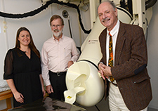 (From left) Drs. Lisa James, Brian Engdahl, and Apostolos Georgopoulos (director) are with the Brain Sciences Center at the Minneapolis VA. They are seen here next to the center's MEG scanner.