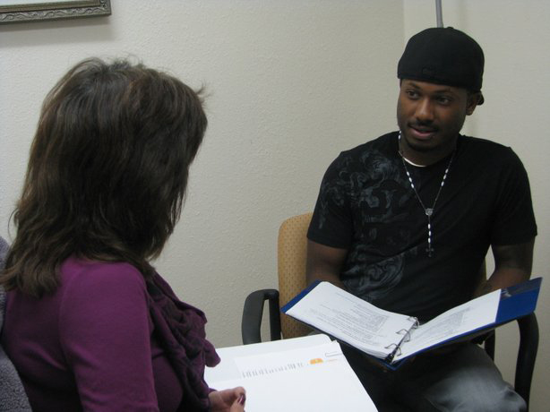 VA employment specialist Laurie Arnold (left) works with Veteran Julian Cook, who suffered a TBI in Iraq. (Photo courtesy of VA San Diego)