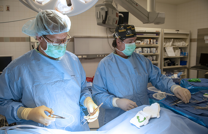 Dr. Daniel Hall (left), seen here in a VA Pittsburgh Healthcare System operating suite with OR technician Mark Yost, is leading efforts to spread preoperative frailty screening in VA. (Photo by Bill George) 