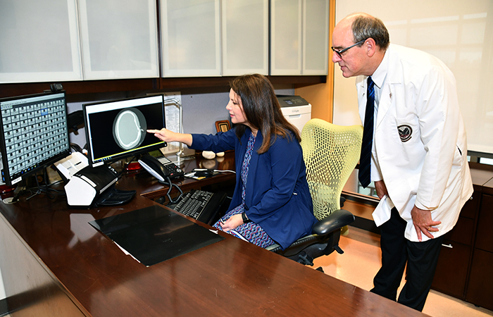 Drs. Steven Scott (standing) and Risa Nakase-Richardson are among a team of researchers studying brain injury at the Tampa VA. (Photo by Ed Drohan)  