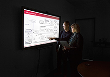 Dr. Jennifer Garvin and doctoral student Youngjun Kim review the architecture of the CHIEF system, which uses natural language processing to extract information from the electronic records of heart failure patients, to help improve their care.  <em>(Photo by Tod Peterson)</em>