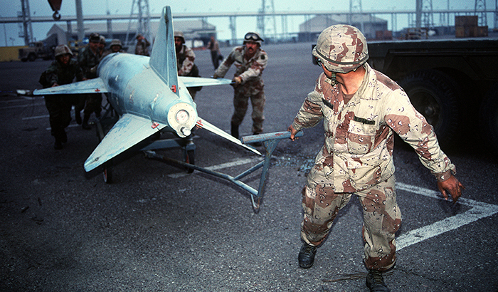 Soldiers pull an HV-2 Silkworm anti-ship missile left behind by retreating Iraqi troops across a pier as captured  equipment and ordnance are prepared for shipment following Operation Desert Storm. (Photo by Joe Gawlowicz/DoD)