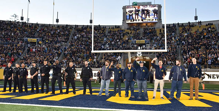 Matthew Smith  (fourth from right) joins other Veterans and first responders who were recognized at an Oct. 21 college football game at California Memorial Stadium for helping the state combat wildfires. Smith helped transport supplies to field hospitals that were set up in Santa Rosa, and arranged for infectious-disease experts from UC-Berkeley to speak with patients.