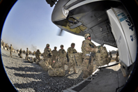 U.S. soldiers from the Guam Army National Guard prepare to board a CH-47 Chinook from Camp Phoenix in Kabul, Afghanistan, in 2013, before heading home. A new public-private study is looking at the factors that help troops reintegrate after deployment. (Photo by Sgt. Eddie Siguenza) 