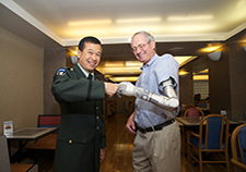  Fred Downs Jr., a Vietnam Veteran and former chief of prosthetics and sensory aids for VA, wears the DEKA prosthetic arm as she shares a light moment with
    Col. Geoffrey Ling of the Defense Advances Research Projects Agency at VA headquarters during National VA Research Week 2012. (Photo by Emerson Sanders)