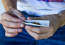  man rolling a joint)