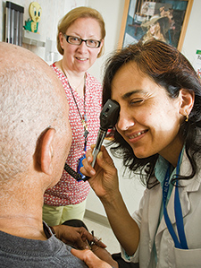    Nurse practitioner Jyoti Desai (right) and nurse Barbara Murphy see an older primary care patient at the Philadelphia VA Medical Center. 