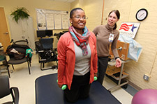 Study participant Raina Groover goes over some exercises with physical therapist Susan Conroy during a clinic visit.