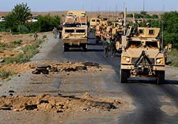   On a southern Afghanistan road in 2010, U.S. Army troops pass by craters that had been created just hours before by improvised explosive devices. IEDs havebeen the main cause of traumatic brain injuries among U.S. troops in recent wars.