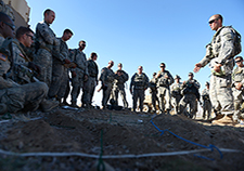 U.S. Army soldiers from the 1st Armored Brigade Combat Team, 3rd Infantry Division, listen to a pre-mission brief in August 2014. <em>(Photo by Senior Airman Daniel Hughes/USAF)</em>  