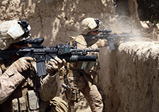 Two Marines with 2nd Battalion, 8th Marine Regiment engage in an operation in Helmand province, Afghanistan, in 2009. Four battalions of Marines took part in a VA San Diego study on heart rate variability, which researchers say is a good measure of the body's fight or flight system. <em>(Photo by Sgt. Pete Thibodeau/USMC)</em>  