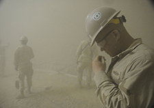 U.S. Navy Petty Officer 2nd Class Eric Clark, a Seabee attached to Naval Mobile Construction Battalion 5, is caught in a sandstorm at Camp Leatherneck, Afghanistan, in May 2010.<em> (Photo by PO2 Ace Rheaume/USN)</em>  