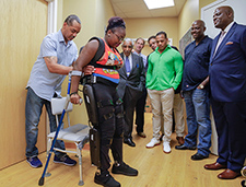  A research participant tries the ReWalk at the Bronx VA Medical Center during a visit by Congressman Charles Rangel, football star Sean James, and others. 
  <em>  (Photo by Lynne Kantor)</em>