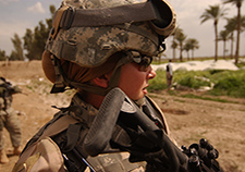  A U.S. Army soldier keeps her weapon at the ready as she provides security during a raid in Al Haswah, Iraq, in 2007. (Photo by Spc. Olanrewaju Akinwunmi)