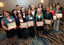 After being recognized for their research, VA investigators pause for a photo at the 2014 VA Women Veterans' Health Services Research Conference. (Photo by Robert Turtil)