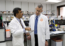 Dr. Sunil Ahuja (left) of VA consults with study collaborator Dr. Matthew Dolan of the Henry M. Jackson Foundation for the Advancement of Military Medicine.