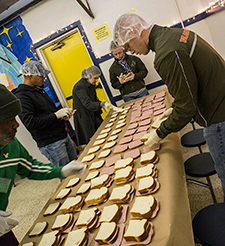 U.S. Marines prepare sandwiches during a volunteer event at a homeless shelter in New Orleans in 2013. A new VA study suggests conducting rapid HIV screening in shelters is a cost-effective way to reach Veterans who are HIV-positive and need care. 