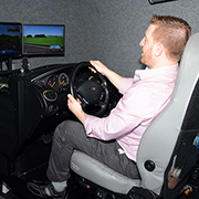 Nicholas Bartolomeo, who served three tours with the Marines in Iraq and now works at VA's Center of Innovation on Disability and Rehabilitation Research in Gainesville, Fla., demonstrates a driving simulator used in research at the center. 