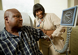 Nurse Charlene Baker checks Lawrence Woodson's blood pressure at the Philadelphia VA Medical Center.