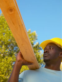 a man lifting a plank of wood